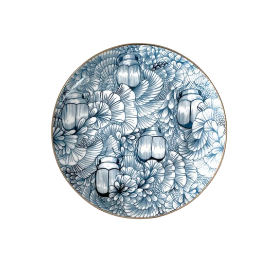 Decorative plate with blue and white floral design on a white background