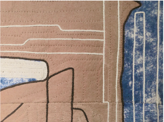 Close-up of a textured fabric with geometric patterns in brown, blue, and white.