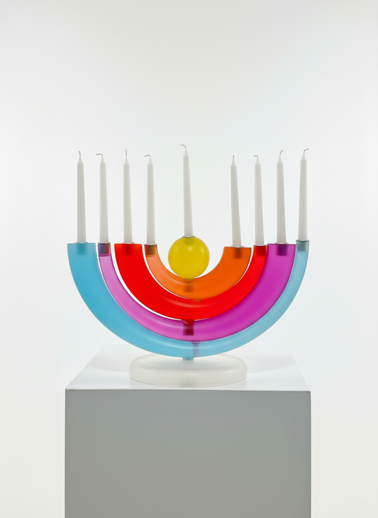 Colorful circular object with candles on a white background