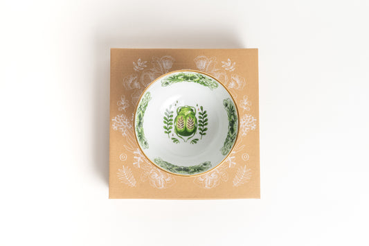 Decorative bowl with green floral design on a matching box
