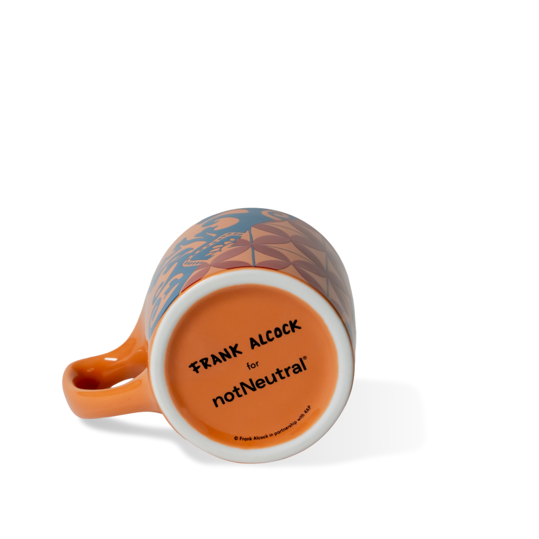 Orange mug with floral pattern on a white background, featuring 'FRANK ALCOCK for notNeutral' text.