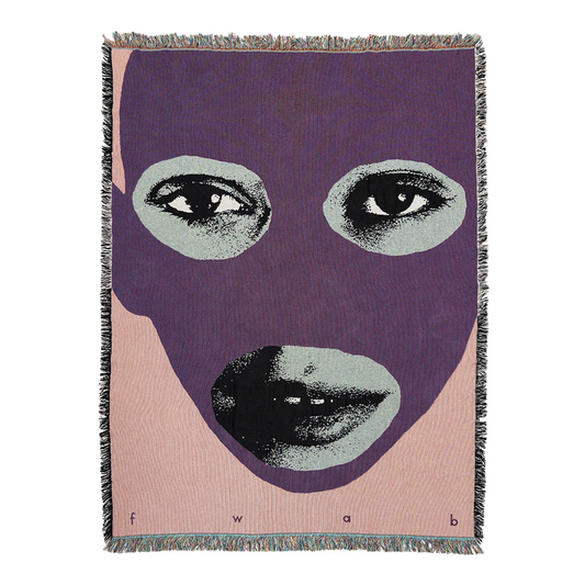 A throw blanket featuring a bold graphic design of a face with predominantly purple features and a pink background, with the letters 'fwab' initials included.