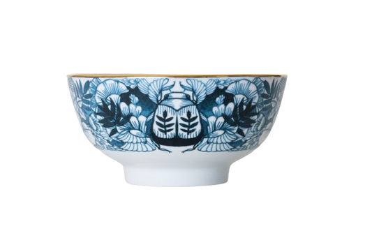 A ceramic bowl with blue floral illustrations and gold accents on a white background.