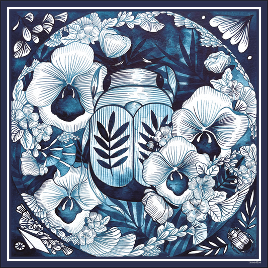 A silk scarf featuring a central illustration of a Scarab beetle surrounded by detailed floral designs in blue tones.