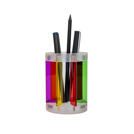 A multicolored modular pencil cup with vertical stripes, designed by Yoni Alter, containing pens inside.