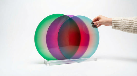 Colorful circular object with a hand reaching towards it on a white background