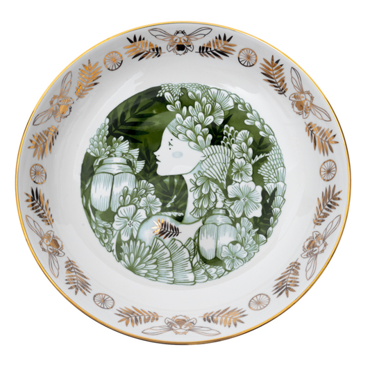 Decorative plate with floral and insect design on a white background