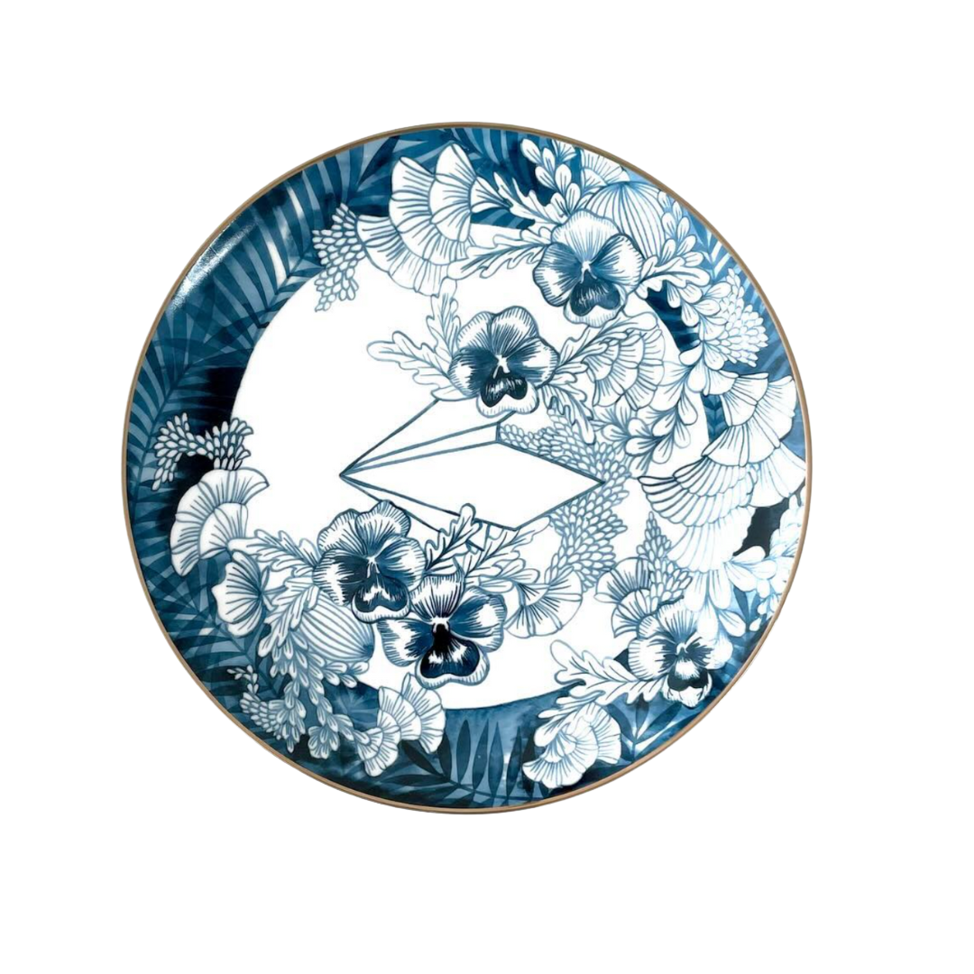 Decorative plate with blue and white floral design on a white background