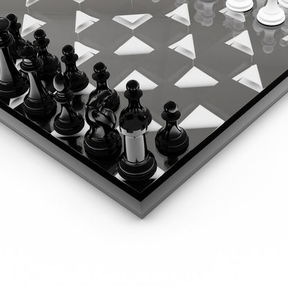 Close-up of a chessboard with black and white pieces on a reflective surface.