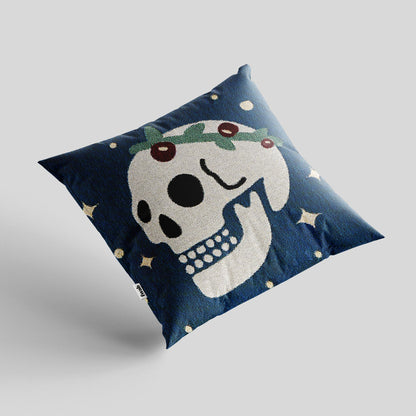 Decorative pillow with a skull design on a blue background