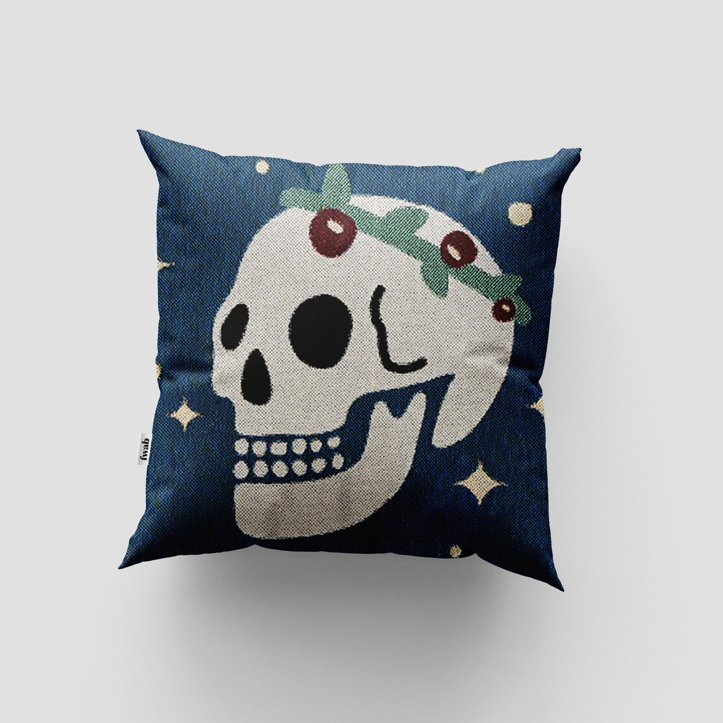 Decorative pillow with skull design on a blue background