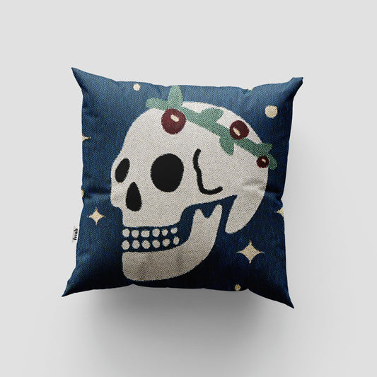 Decorative pillow with skull design on a blue background