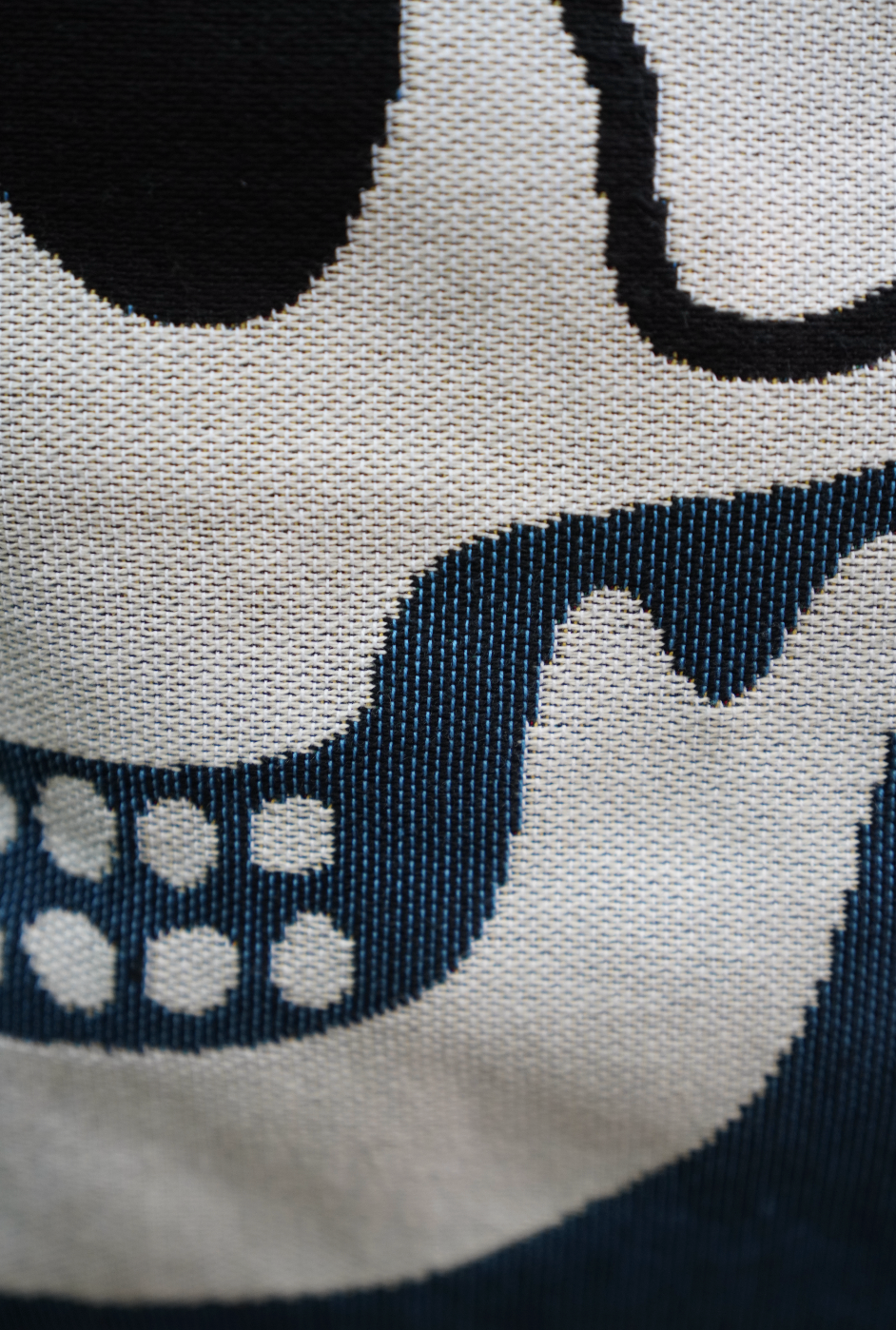 Close-up of a skull design on fabric with black and white colors.