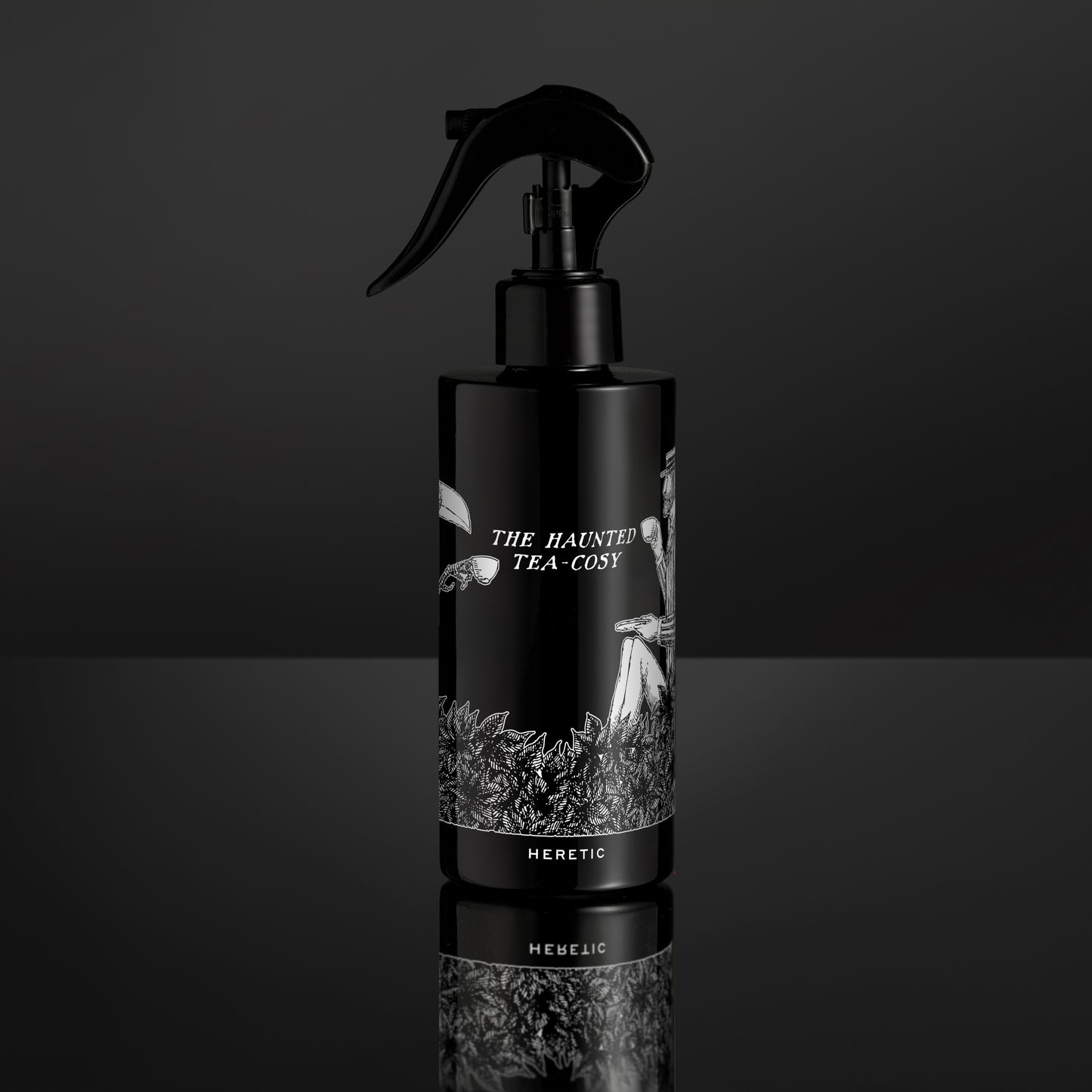 Black spray bottle with 'The Haunted Tea Cosy' label on a black background