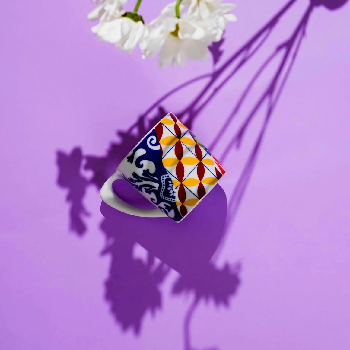 Colorful mug with geometric pattern on a purple background