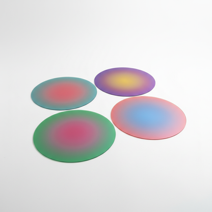 Four round, colorful objects on a light gray background