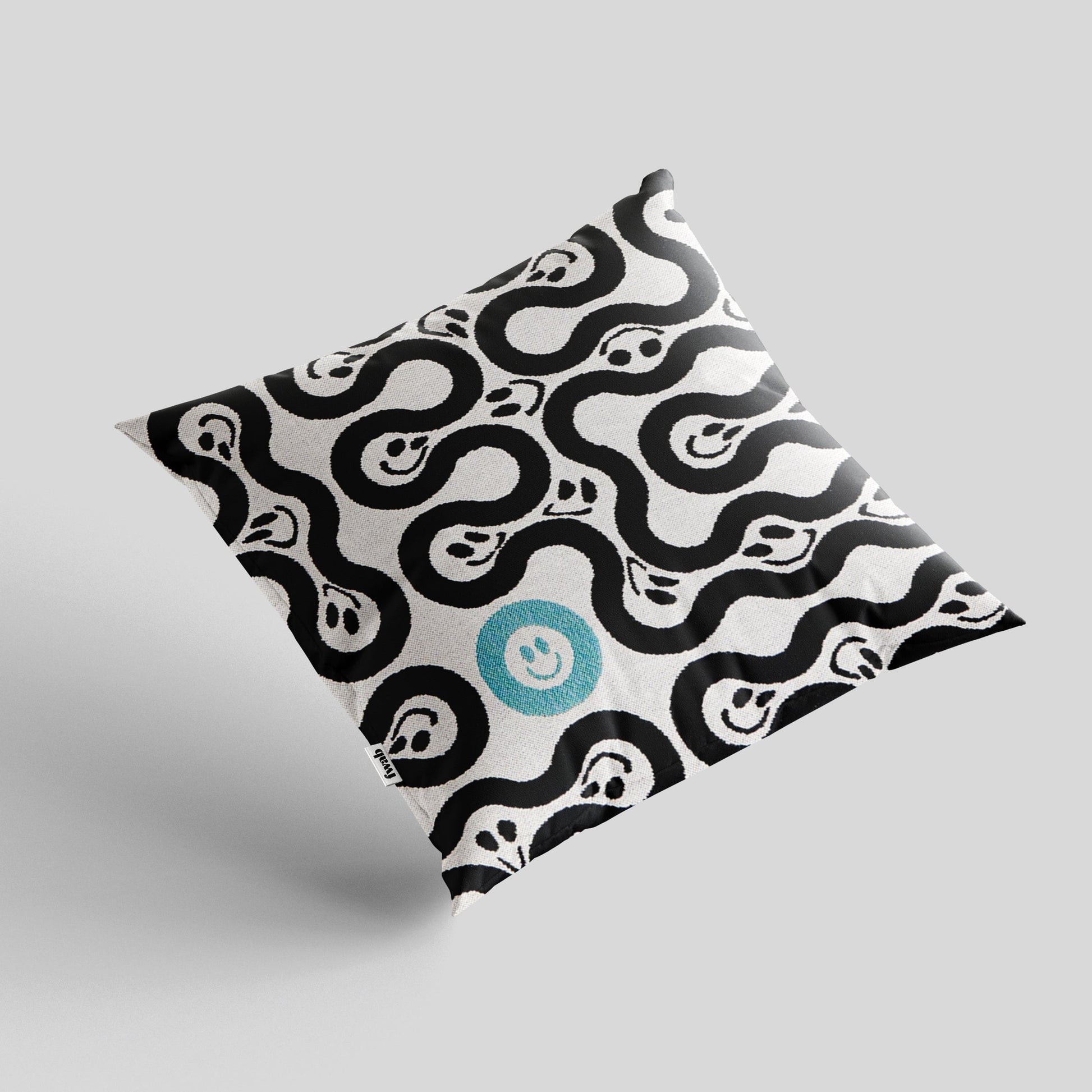 Patterned pillow with a central blue circle on a light gray background