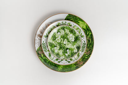 Set of decorative plates with green leaf patterns on a white background