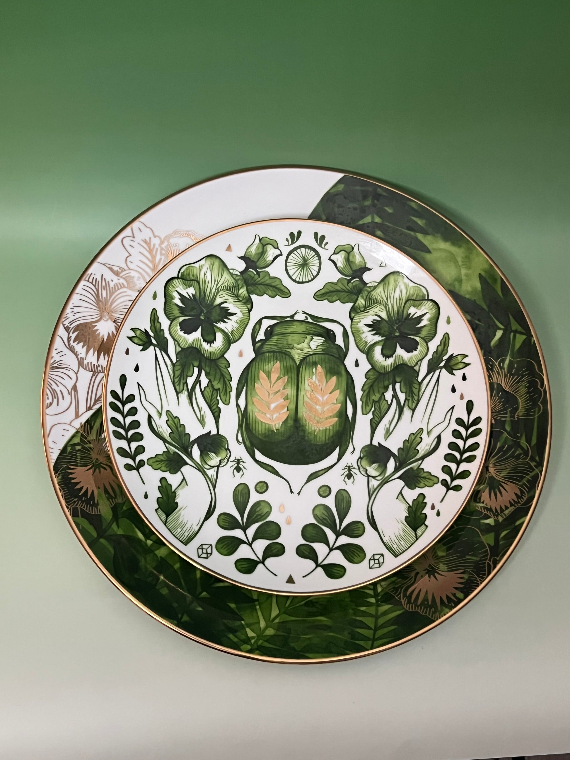 Decorative plate with green floral design on a white background
