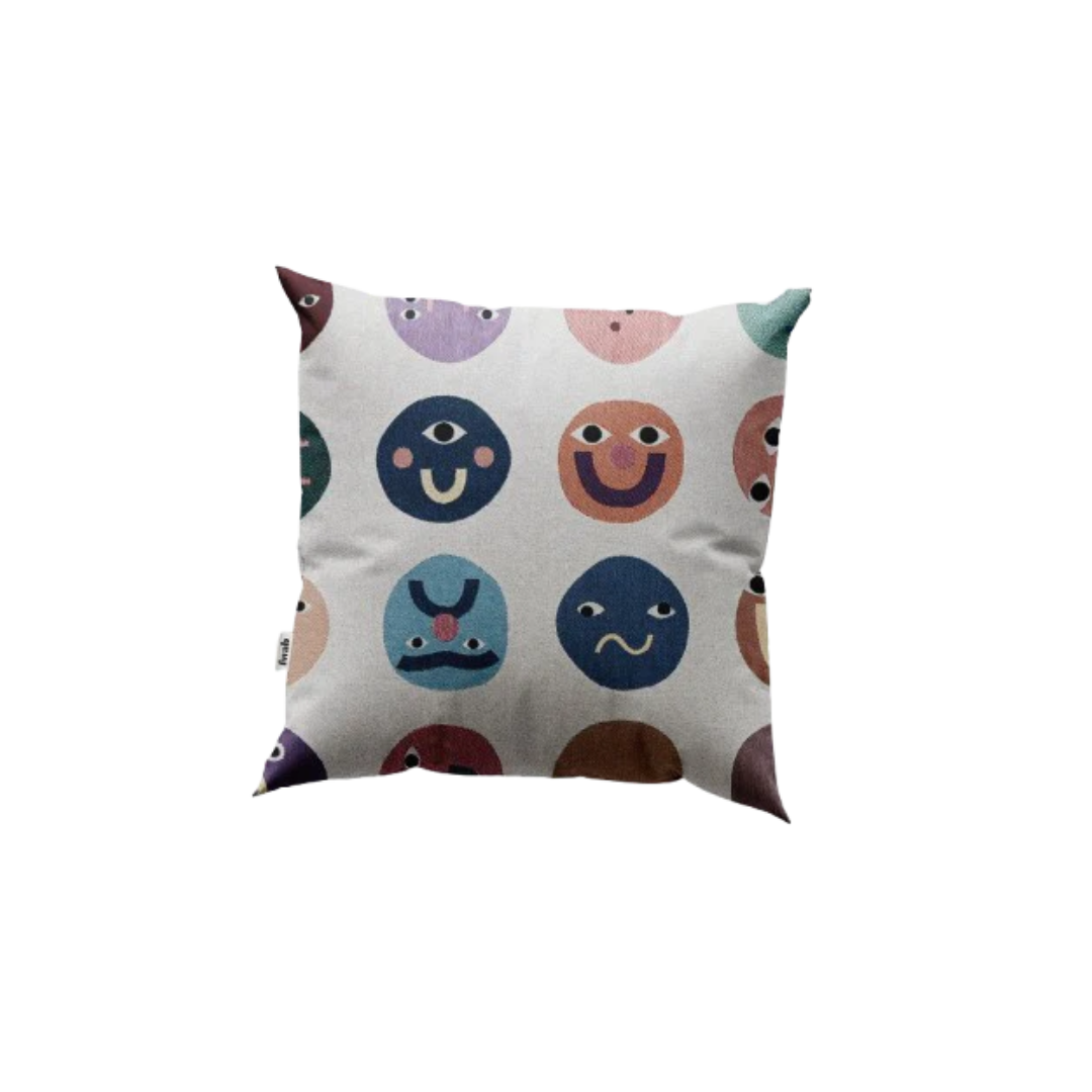 Decorative pillow with colorful smiley face patterns on a white background