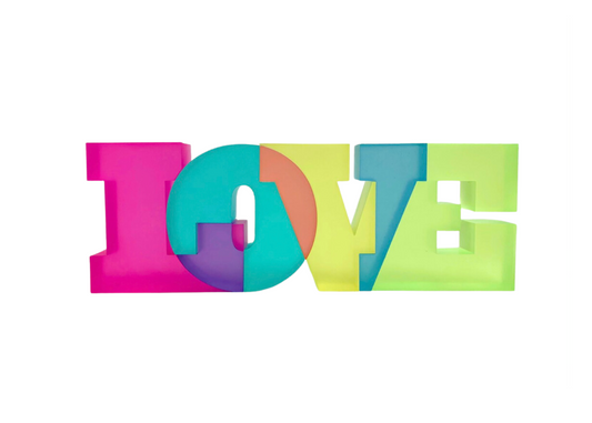 A colorful translucent sculpture spelling out the word 'LOVE' in bold letters.