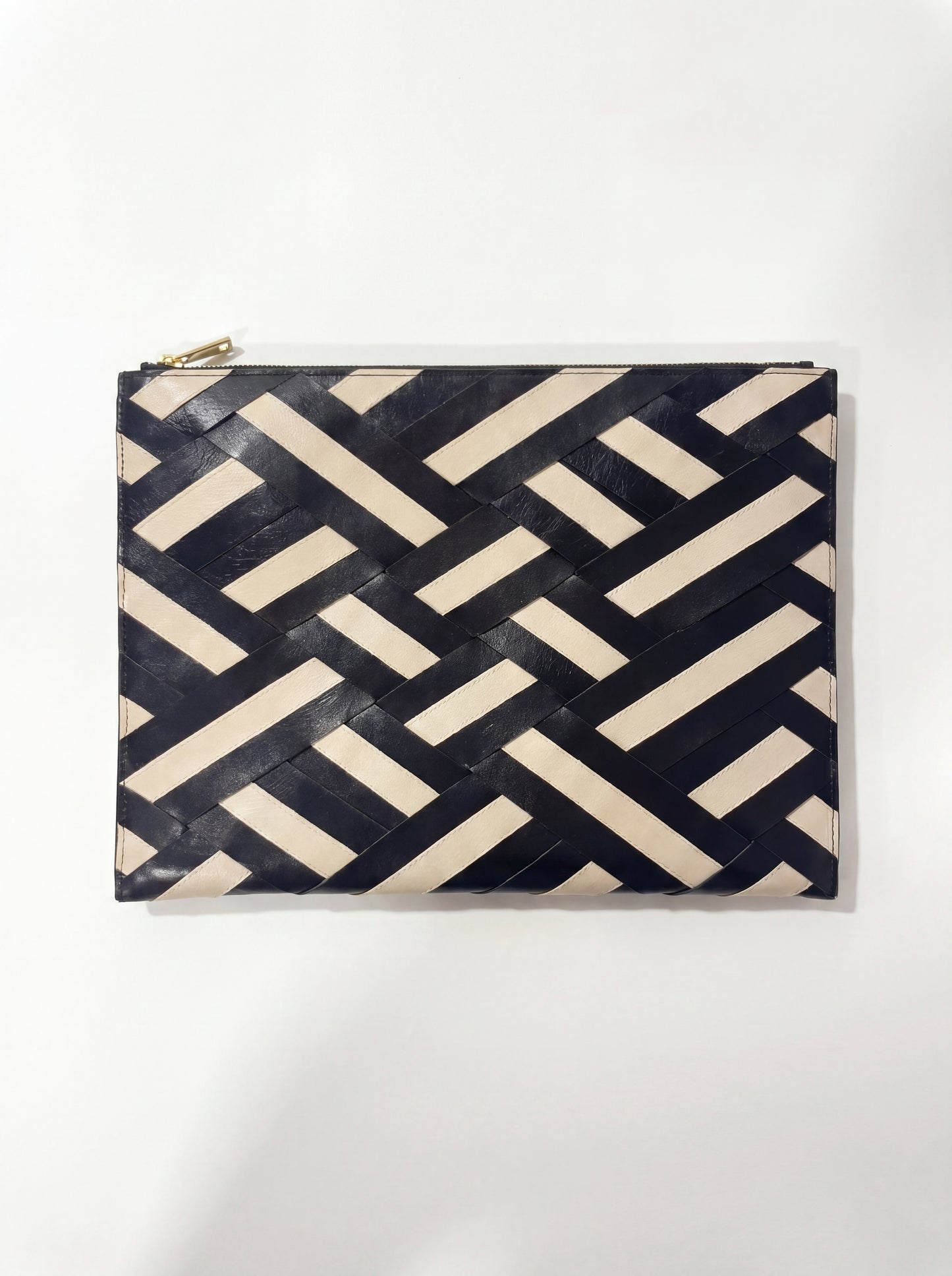 Laptop sleeve with a geometric black and beige pattern on a white background
