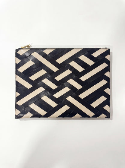 Laptop sleeve with a geometric black and beige pattern on a white background
