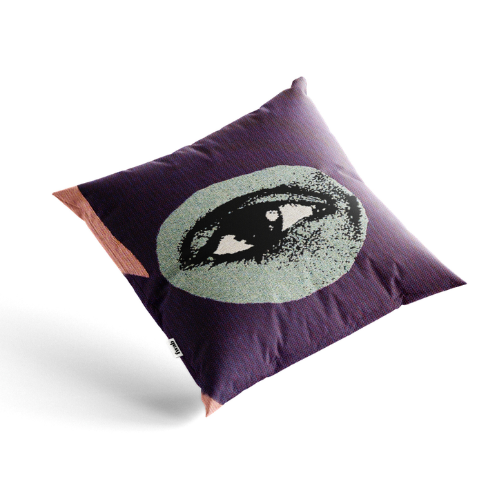 Purple pillow with a graphic design of an eye on a white background