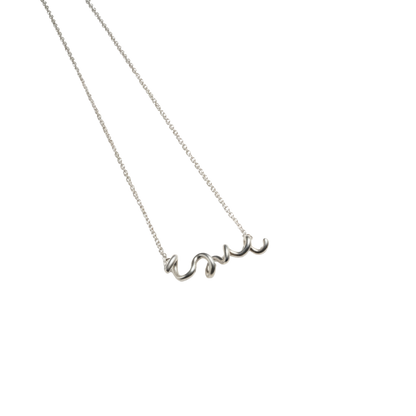 Silver necklace with 'love' pendant on a white background