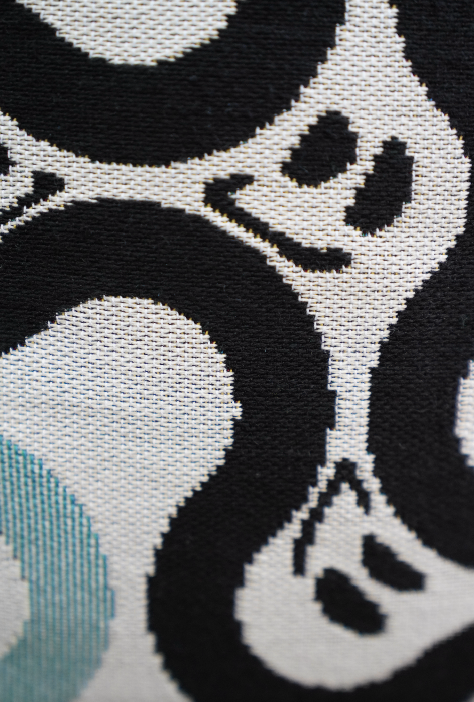 Close-up of a black and white patterned fabric with abstract shapes.