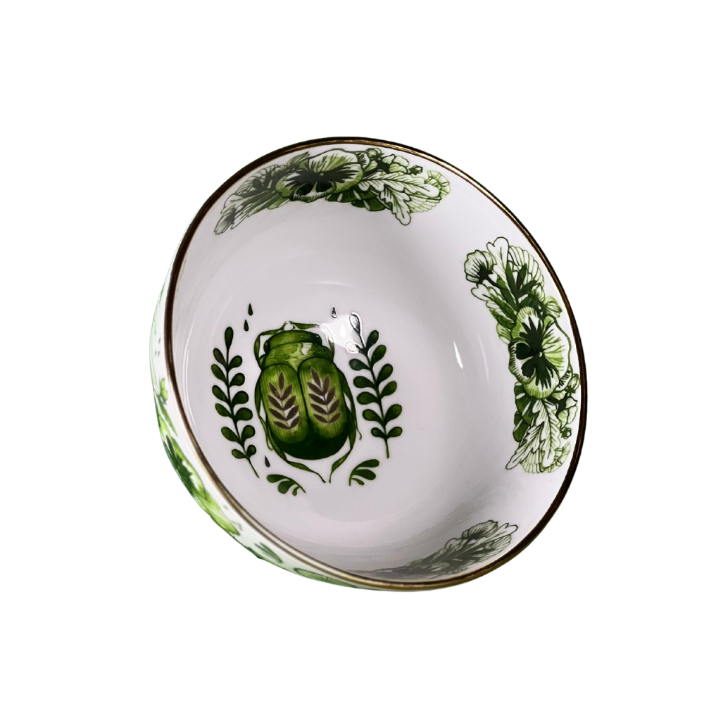 Decorative bowl with green leaf patterns on a white background