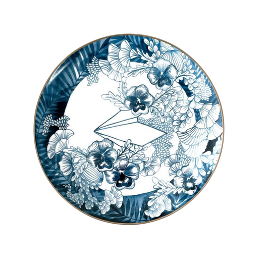 Decorative plate with blue and white floral design on a white background
