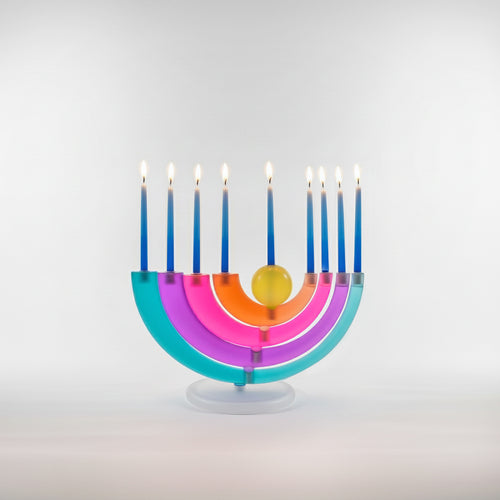 Colorful menorah with lit candles on a light gray background