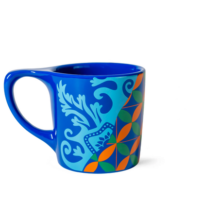 Blue mug with colorful geometric pattern on a white background