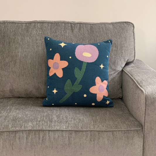 Decorative pillow with floral design on a gray couch