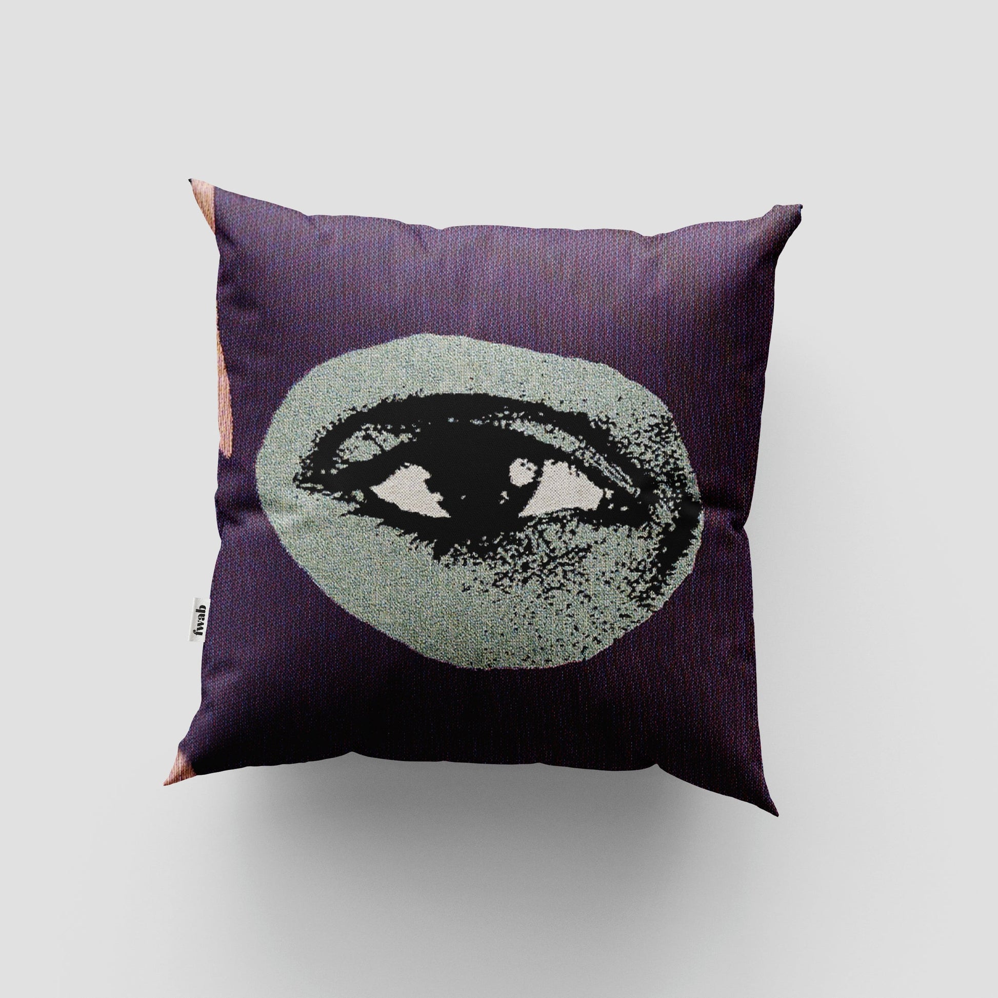 Decorative pillow with eye design on a plain background