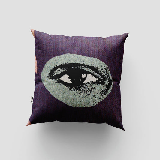 Decorative pillow with eye design on a plain background