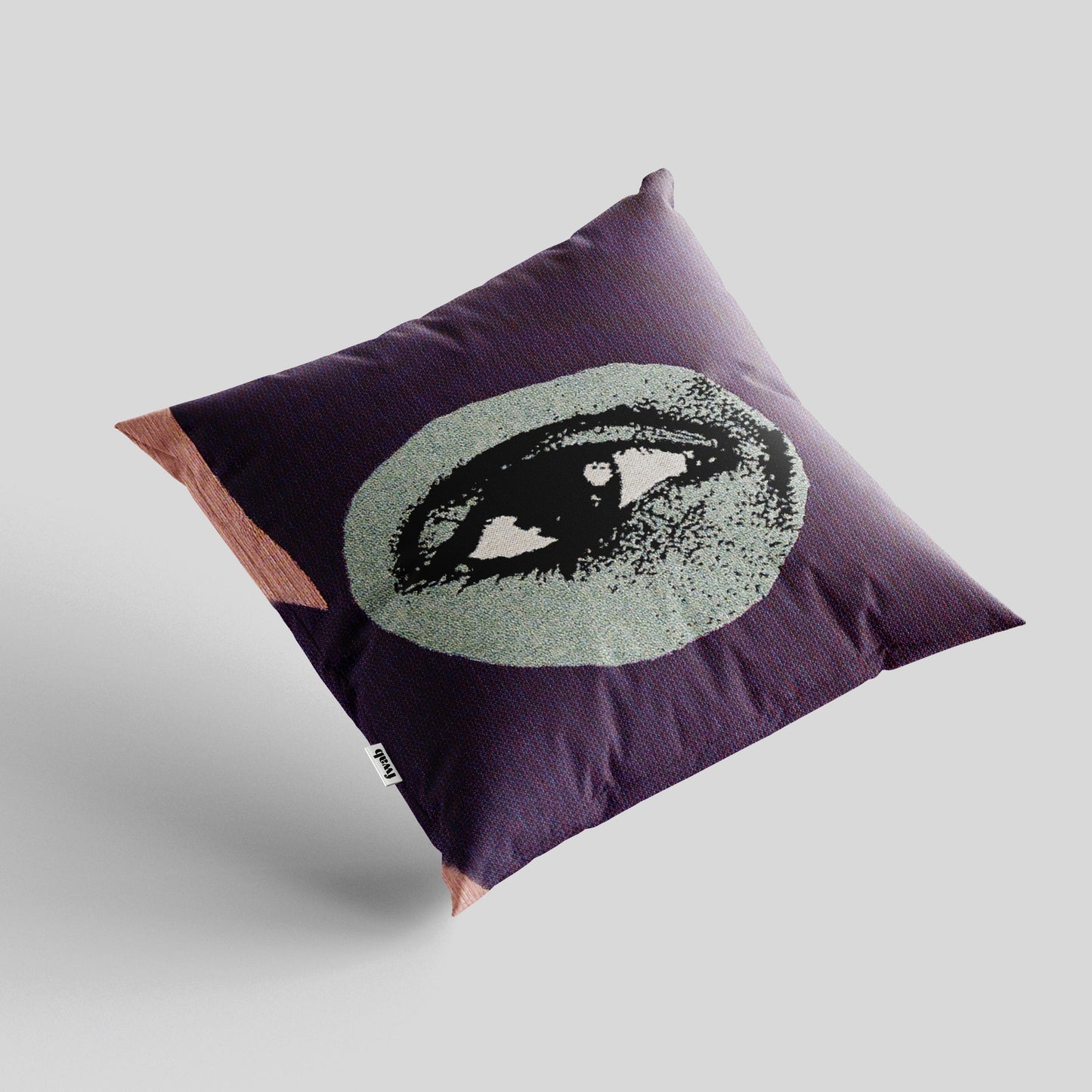 Decorative pillow with eye design on a plain background