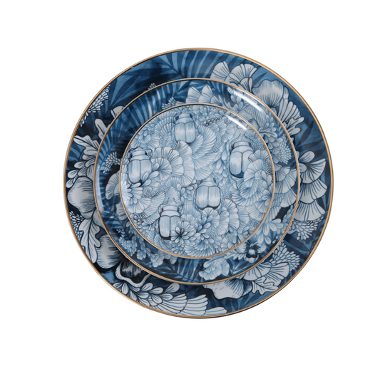 A set of blue and white floral patterned plates with gold trim.
