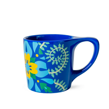 Blue mug with floral design on a white background