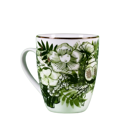 White mug with green floral pattern on a white background