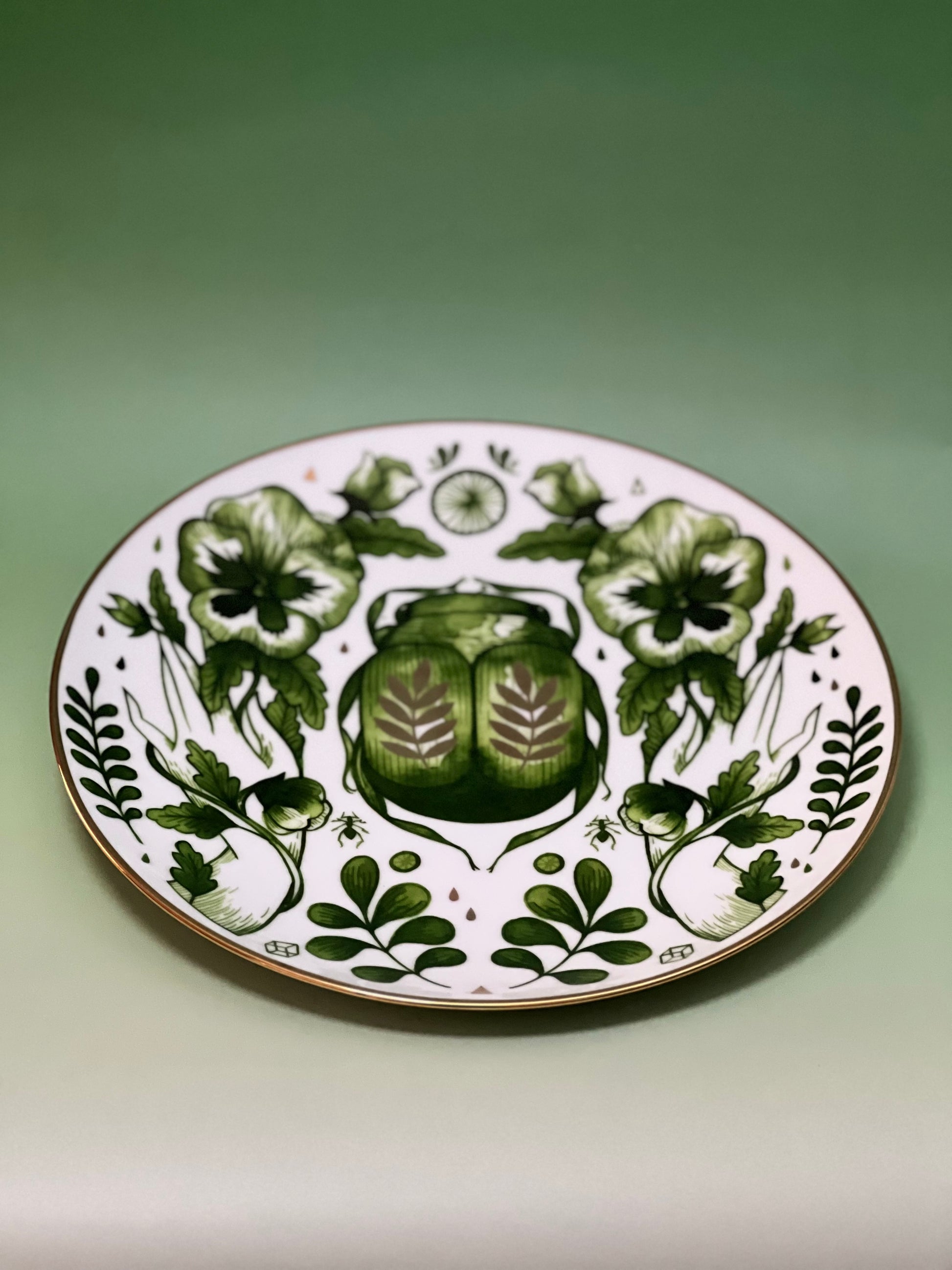 Decorative plate with green floral design on a white background
