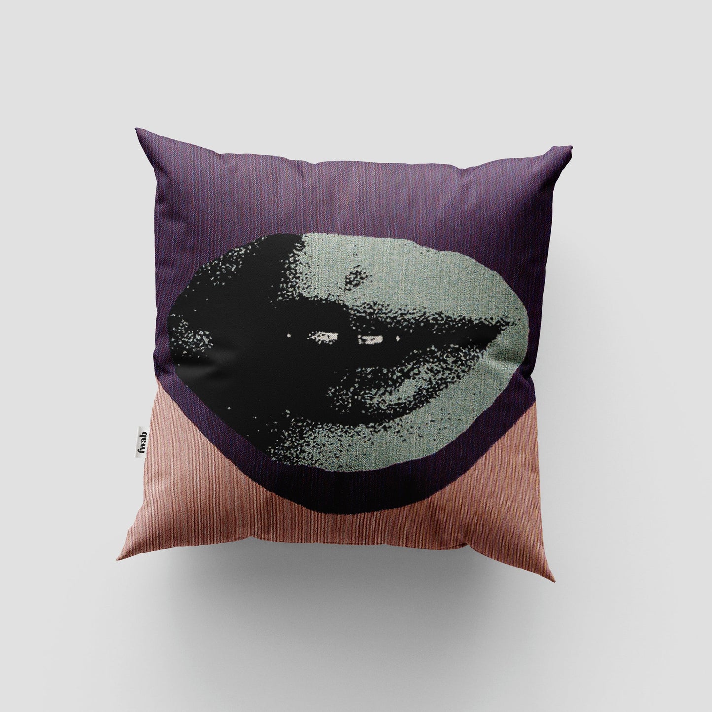 Decorative pillow with a face design on a plain background