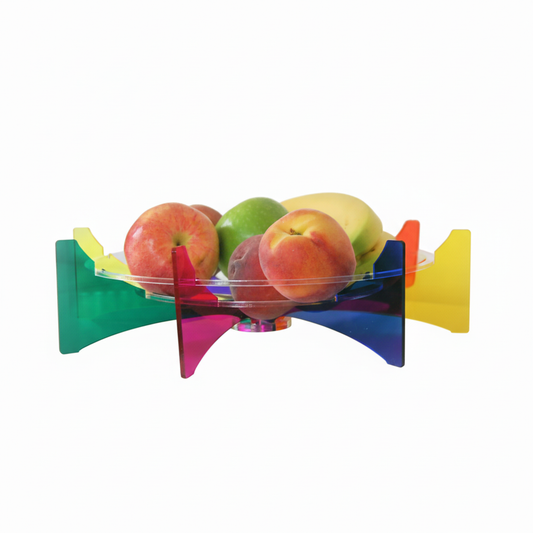 Colorful fruit bowl with apples and peaches on a white background