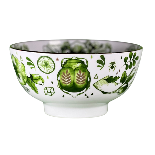 Decorative bowl with green leaf pattern on a white background