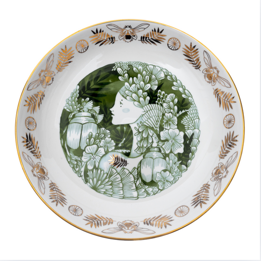 Decorative plate with floral and insect design on a white background
